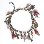 "Life of Jesus" bracelet. Red, purple and copper coloured beads with Christian symbols - BRSF901