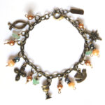"Life of Jesus" bracelet. Copper, peacock and peach coloured beads and freshwater pearls with Christian symbols - BRSF901A